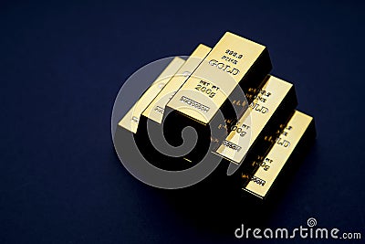 gold bars stacked in a pyramid shape. Shiny precious metals for investments or reserves. Stock Photo