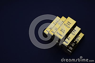 Gold bars stacked in a pyramid shape. Shiny precious metals for investments or reserves. Stock Photo