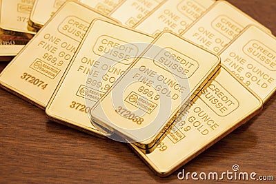 Gold Bars on Wood Surface Editorial Stock Photo