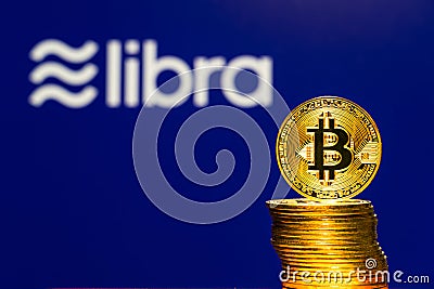 Bitcoin Coins with the Facebook Libra Crypto Coin logo Editorial Stock Photo