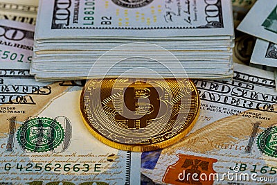 Gold bitcoin coins on one hundred US dollar bills background. Cryptocurrency, New digital currency, Bitcoin exchange to dollar mon Stock Photo