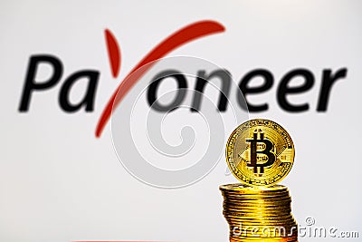 Gold Bitcoin coins with the Payoneer logo Editorial Stock Photo