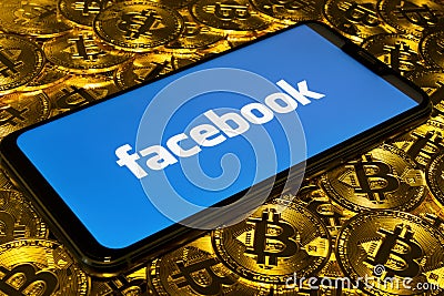 Gold Bitcoin coins pile with the Facebook logo Editorial Stock Photo