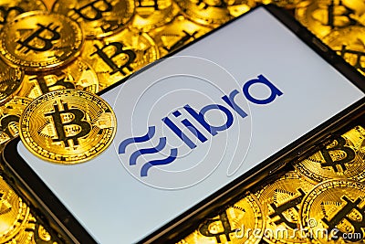 Gold Bitcoin Coins pile with the Facebook`s Libra Crypto Coin Editorial Stock Photo