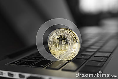 Gold Bitcoin crypto coin on a laptop keyboard. Exchange, bussiness, commercial. Profit from mining crypt currencies Stock Photo