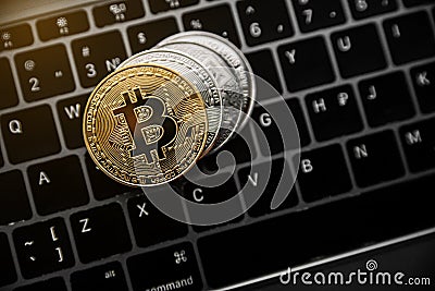 Gold bitcoin on the coins stack, digital money on computer keyboard. Cryptocurrency business concept. Virtual money Editorial Stock Photo