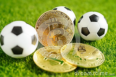 Gold bitcoin with soccer ball or football, cryptocurrency used in online sports betting Stock Photo