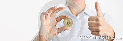 Gold bitcoin and thumbs up in female hand Editorial Stock Photo