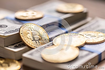 Gold Bitcoins on American Banknotes. Online trading between US currency and cryptocurrency Stock Photo