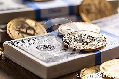 Gold Bitcoins on American Banknotes. Online traing between US currency and cryptocurrency. Stock Photo