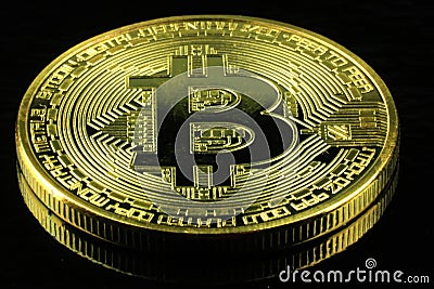 Gold Bitcoins cryptocurrency money on a black background Stock Photo