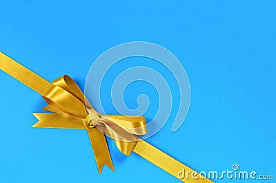 Gold bow gift ribbon corner diagonal blue background Stock Photo