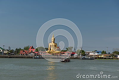 gold Buddha by Chao Phraya river at Wat Bang Chak, Nonthaburi Stock Photo