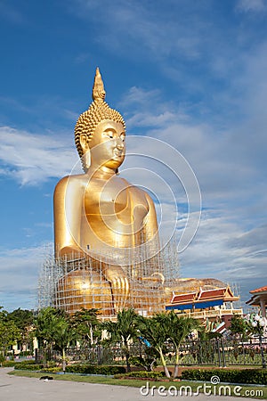 Gold buddha statue under construction in Thai temple with clear sky.WAT MUANG, Ang Thong, THAILAND. Stock Photo