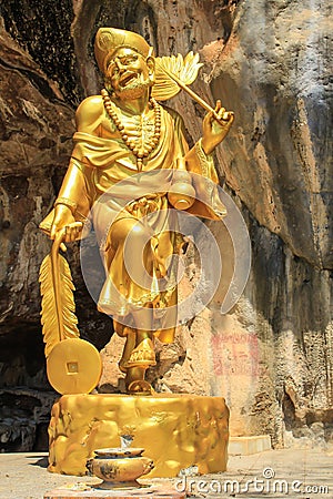The gold buddhism statue in the cave Stock Photo