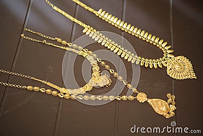 Gold chain on a brown background Stock Photo