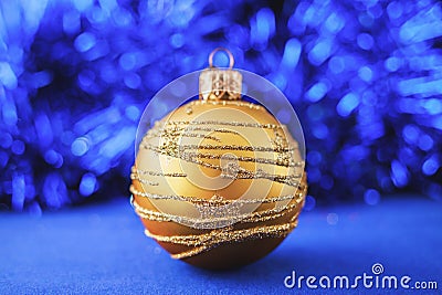 Gold Christmas ornament on blue holiday background. Xmas and New Year Stock Photo