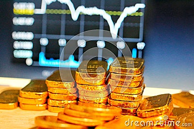 Gold coins, gold bars, sorting, concept, saving, education, gold investment Forex trading, stock table background blur Stock Photo