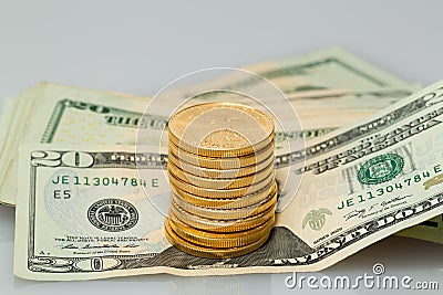 Stack of $20 dollar bills with gold coins Stock Photo