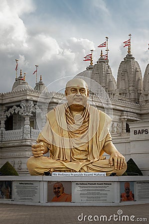 The gold colored statue of spiritual leader holiness pramukh swami maharaj front of Neasden temple Editorial Stock Photo