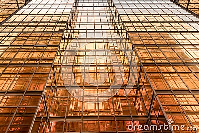 Gold colour office building tower facade in business center Stock Photo