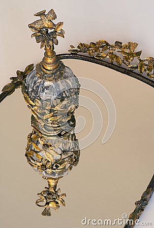 Gold crystal perfume on vanity mirror Stock Photo