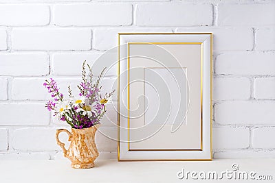 Gold decorated frame mockup with chamomile and purple flowers in Stock Photo