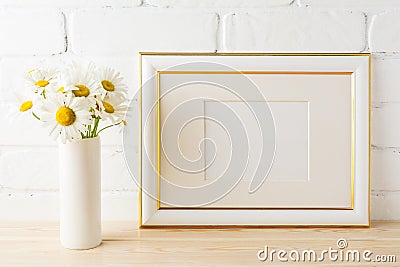 Gold decorated landscape frame mockup with daisy flower in vase Stock Photo