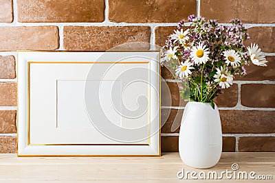 Gold decorated landscape frame mockup with wildflowers bouquet i Stock Photo