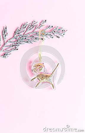 Gold decoration cat on a silver twig on a pink background. Merry christmas concept. Stock Photo