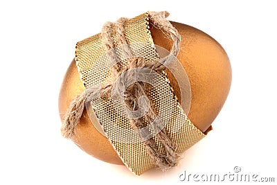 Gold EASTER egg wrapped by golden bow Stock Photo