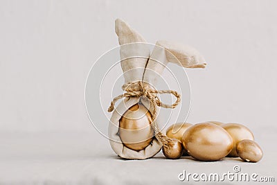 Gold Easter Eggs in Natural Linen Textile Stock Photo