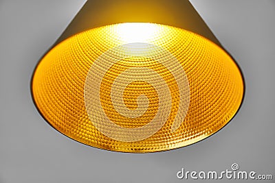 Gold embossed lampshade. Round yellow lamp on grey background Stock Photo