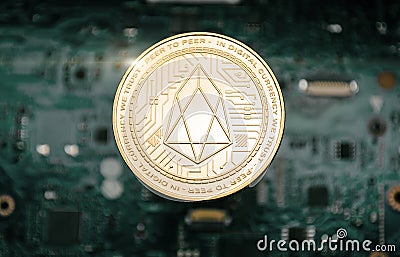 Gold eos coin, on background of computer motherboard Stock Photo