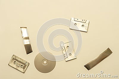 Gold fancy retro old audio cassettes, film strip, disc on beige color background. Horizontal media theme poster, greeting cards, h Stock Photo