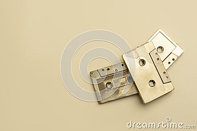 Gold fancy retro old audio cassettes tape on beige color background. Retro mixtape, 1980s pop songs tapes and stereo music cassett Stock Photo