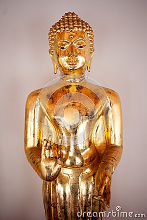 Gold figure of Buddha in temple Bangkok, Thailand. Close-up Stock Photo