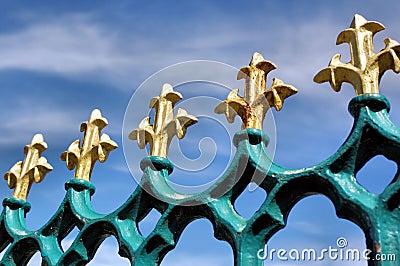 Gold fleur de lis on blue iron railings Stock Photo