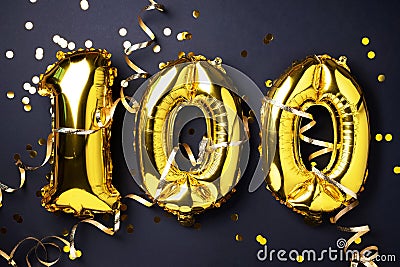 Gold foil balloon number, digit one hundred. Birthday greeting card with inscription 100. Anniversary celebration Stock Photo