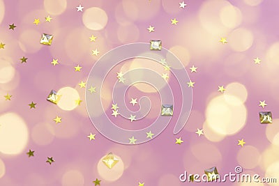 Gold gems and star confetti on a pastel pink background Stock Photo