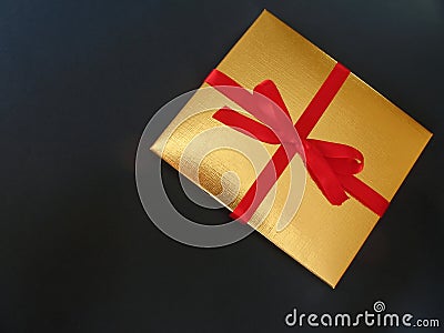 Gold gift box red ribbon - 1 Stock Photo