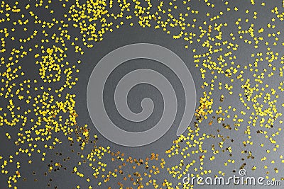 Gold glitter stars circle on black background Stock Photo