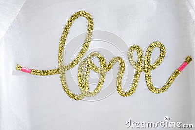 The gold hand craft text Love typo knitting on the white textile Stock Photo