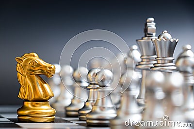 Gold horse chess piece face silver team on black background Stock Photo