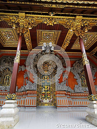 A gold-incrustated door at an inner court of a private house on Bali island in Indonesia Stock Photo