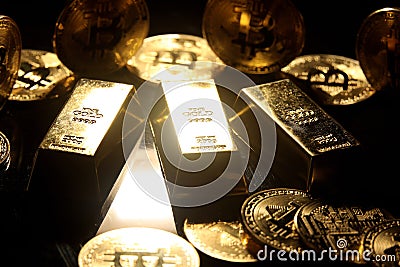 Gold ingot and bitcoin against black background Stock Photo