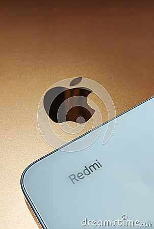 Gold iPad and Xiaomi Redmi 12 Sky Blue color. Editorial Stock Photo
