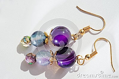 gold jewerly earrings with agat and fluorite semiprecious at white background Stock Photo