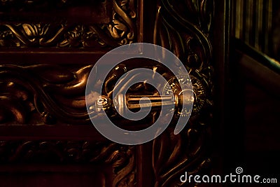 Gold lever door handle on decorative architectural detail Stock Photo