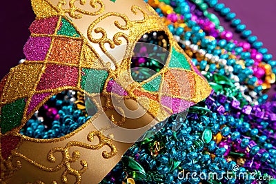 Gold mardi gras mask and beads Stock Photo